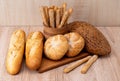 ÃÂ¡risp bread with buns. French baguettes. Fresh crispbread. Bread background. Different breed on wooden background